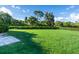 Spacious grassy backyard with a partially visible patio at 2771 Golf Course Dr # 101, Sarasota, FL 34234