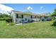 Tan house with green accents and a small front patio at 2771 Golf Course Dr # 101, Sarasota, FL 34234