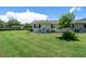 Ranch style home with green lawn and trees at 2771 Golf Course Dr # 101, Sarasota, FL 34234