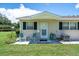 Front view of a light tan house with green shutters at 2771 Golf Course Dr # 101, Sarasota, FL 34234