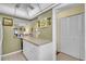 White kitchen with breakfast bar and access to the dining area at 2771 Golf Course Dr # 101, Sarasota, FL 34234