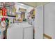 Laundry room with washer, dryer, and storage shelves at 2771 Golf Course Dr # 101, Sarasota, FL 34234