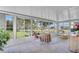Sunroom with ample natural light and seating area at 2771 Golf Course Dr # 101, Sarasota, FL 34234