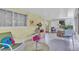 Bright sunroom with tiled floor and garden views at 2771 Golf Course Dr # 101, Sarasota, FL 34234