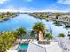 Aerial view showcasing the property, pool, and canal views at 445 115Th Ave, Treasure Island, FL 33706