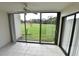 Bright sunroom with tiled floor and sliding glass doors opening to a grassy yard at 4604 Longwater # 77, Sarasota, FL 34235