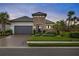 Inviting curb appeal featuring a stone facade and a 2-car garage at 4708 Trento Pl, Bradenton, FL 34211