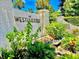 Westchester community entrance featuring stone signage, lush landscaping, and brick pillars, offering a welcoming first impression at 4825 Gulf Of Mexico Dr # 304, Longboat Key, FL 34228