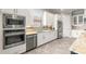 Modern kitchen with stainless steel appliances and white cabinets at 5011 Tivoli Run, Bradenton, FL 34211