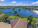 A scenic aerial view highlighting the lake and palm trees at 518 Luminary Blvd, Osprey, FL 34229