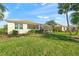Well-manicured lawn and landscaping surround the home's rear exterior at 518 Luminary Blvd, Osprey, FL 34229