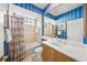 Bathroom with blue striped walls, vanity, shower and tub at 518 Luminary Blvd, Osprey, FL 34229