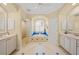 Spacious bathroom featuring dual vanities, tiled floor, and bath at 518 Luminary Blvd, Osprey, FL 34229