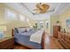 Bright bedroom with hardwood floors, ceiling fan, and multiple windows at 518 Luminary Blvd, Osprey, FL 34229