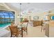 Bright dining area features tile floors, pendant lighting, and a large window overlooking the screened pool and lake at 518 Luminary Blvd, Osprey, FL 34229