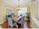 Dining room featuring wood floors, a modern chandelier, and neutral wall paint at 518 Luminary Blvd, Osprey, FL 34229