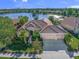 Stunning lakefront home featuring manicured landscaping, a three-car garage, and a tile roof at 518 Luminary Blvd, Osprey, FL 34229