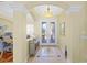 Elegant foyer with decorative tile flooring, a stylish chandelier, and custom glass entry doors at 518 Luminary Blvd, Osprey, FL 34229