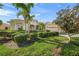 Charming single-story home featuring lush landscaping, a well-manicured lawn and a two-car garage at 518 Luminary Blvd, Osprey, FL 34229