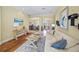 Bright living room features hardwood floors, neutral paint, stylish decor, and an arched doorway to the dining room at 518 Luminary Blvd, Osprey, FL 34229