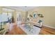 Well-lit living room with hardwood floors, neutral paint, stylish furniture, and arched doorway to the foyer at 518 Luminary Blvd, Osprey, FL 34229