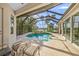 A stunning screened-in pool featuring a waterfall spa, surrounded by a spacious deck perfect for relaxing at 518 Luminary Blvd, Osprey, FL 34229