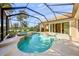 A gorgeous screened-in pool featuring a waterfall spa with access to the house and yard at 518 Luminary Blvd, Osprey, FL 34229