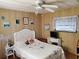 Cozy bedroom with a white wicker headboard and wall decor at 5504 Bermuda Ct, Bradenton, FL 34207