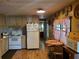 Bright kitchen offers eat-in area and views to the hallway at 5504 Bermuda Ct, Bradenton, FL 34207