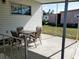 Covered patio with table and chairs, offering outdoor dining space at 5504 Bermuda Ct, Bradenton, FL 34207