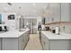 Modern kitchen with gray cabinets, white countertops and a large island at 5726 Mezzana Run, Palmetto, FL 34221