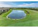Aerial view of community with pond, golf course, and homes at 6055 Worsham Ln # 104, Lakewood Ranch, FL 34211