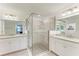 Elegant bathroom with double sinks, granite countertops, and a large glass shower at 6055 Worsham Ln # 104, Lakewood Ranch, FL 34211