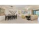 Open dining area with farmhouse table and chairs at 6055 Worsham Ln # 104, Lakewood Ranch, FL 34211