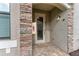 Front entry with brick accents and glass door at 6055 Worsham Ln # 104, Lakewood Ranch, FL 34211