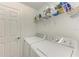 Laundry room with washer, dryer, and shelving at 6055 Worsham Ln # 104, Lakewood Ranch, FL 34211