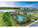 Community pool with surrounding lounge chairs at 6055 Worsham Ln # 104, Lakewood Ranch, FL 34211