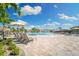 Large resort-style pool with waterfall feature and lounge chairs at 6055 Worsham Ln # 104, Lakewood Ranch, FL 34211