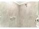 Walk-in shower with grab bars and neutral-toned tile at 6055 Worsham Ln # 104, Lakewood Ranch, FL 34211