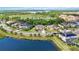 Aerial view of a home on a large .31 acre private lot, surrounded by lush greenery and a lake at 6318 Anise Dr, Sarasota, FL 34238