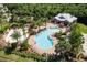 Aerial view of the community pool, lounge area, and water park surrounded by palm trees at 6318 Anise Dr, Sarasota, FL 34238