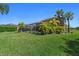 Lush backyard showcasing a screened-in pool, tropical landscaping, and plenty of green space at 6318 Anise Dr, Sarasota, FL 34238