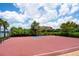 Community basketball court with black chain link fence and lake view at 6318 Anise Dr, Sarasota, FL 34238