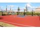Community basketball and volleyball court next to a lake, providing opportunities for sports and recreation at 6318 Anise Dr, Sarasota, FL 34238
