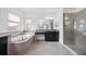 Spacious bathroom with soaking tub, glass-enclosed shower, and granite vanity at 6318 Anise Dr, Sarasota, FL 34238