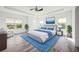 Bright bedroom featuring a tray ceiling, ceiling fan and decor with blue accents at 6318 Anise Dr, Sarasota, FL 34238