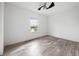 Bright, empty bedroom with a ceiling fan and a window offering scenic view at 6318 Anise Dr, Sarasota, FL 34238