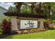 Arbor Lakes on Palmer Ranch community sign with lush landscaping, stone accents and mature palm trees at 6318 Anise Dr, Sarasota, FL 34238