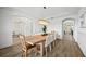 Bright dining area with wood-look tile floors and decorative chandelier lighting at 6318 Anise Dr, Sarasota, FL 34238