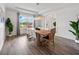 Open dining area with water view, wood-look tile, and statement chandelier at 6318 Anise Dr, Sarasota, FL 34238